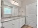 Bathroom features double sinks with granite countertops and a large mirror at 1547 South Bethany Rd, Locust Grove, GA 30248