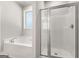 Bright bathroom showcases a luxurious tub, shower stall, and window at 1547 South Bethany Rd, Locust Grove, GA 30248