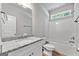 Clean bathroom with a white vanity, granite countertop, and a shower/tub combo at 1547 South Bethany Rd, Locust Grove, GA 30248