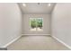 Bright bedroom showcases neutral carpet and natural light from a single window at 1547 South Bethany Rd, Locust Grove, GA 30248