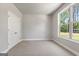 Carpeted bedroom with grey walls, a window, and a closet in the room at 1547 South Bethany Rd, Locust Grove, GA 30248