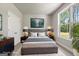Staged primary bedroom with a plush rug, grey walls, and a large window at 1547 South Bethany Rd, Locust Grove, GA 30248