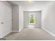 Bright bedroom features neutral carpet and natural light from a single window at 1547 South Bethany Rd, Locust Grove, GA 30248