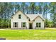 Beautiful home with white siding, black shutters, and a well-manicured lawn surrounded by many trees at 1547 South Bethany Rd, Locust Grove, GA 30248