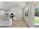 Open kitchen area featuring bright windows, granite counters, and stainless appliances at 1547 South Bethany Rd, Locust Grove, GA 30248
