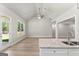Open kitchen and living area featuring hard wood floors, granite counters and stainless sink at 1547 South Bethany Rd, Locust Grove, GA 30248