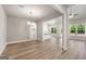 Open-concept living room with wood flooring, recessed lighting, and large windows bringing in natural light at 1547 South Bethany Rd, Locust Grove, GA 30248