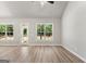 Open living area featuring hard wood floors, bright windows, and neutral paint at 1547 South Bethany Rd, Locust Grove, GA 30248