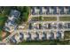 Aerial view showcases an organized community layout with townhomes, green spaces, and a pool at 2929 Rambler Dr, Loganville, GA 30052