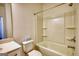 Well lit bathroom with a shower and tub combo, as well as a toilet with a tissue box on top at 2929 Rambler Dr, Loganville, GA 30052