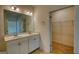 Bathroom featuring double sink vanity, large mirror, and walk in closet at 2929 Rambler Dr, Loganville, GA 30052