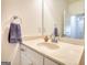 Bathroom featuring white cabinets with silver hardware, a white countertop, and a framed mirror at 2929 Rambler Dr, Loganville, GA 30052