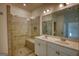 Bathroom featuring walk-in shower with tile surround, double sink vanity and tile floors at 2929 Rambler Dr, Loganville, GA 30052