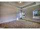 Unfurnished bedroom featuring neutral walls and carpeting, tray ceiling, and two windows at 2929 Rambler Dr, Loganville, GA 30052