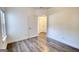 This bedroom features laminate floors, light walls, a window, and an interior door at 2929 Rambler Dr, Loganville, GA 30052