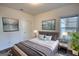 A furnished bedroom with hardwood floors, lamps, and a large window for lots of light at 2929 Rambler Dr, Loganville, GA 30052