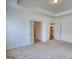 Unfurnished bedroom featuring neutral walls and carpeting with access to bathroom and kitchen at 2929 Rambler Dr, Loganville, GA 30052