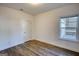 Bedroom featuring hardwood floors, white trim, white walls, and a door at 2929 Rambler Dr, Loganville, GA 30052
