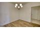 Bright dining room featuring wood floors and a modern chandelier fixture at 2929 Rambler Dr, Loganville, GA 30052