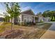 Inviting exterior showcasing neutral siding, a charming front porch, and well-maintained landscaping at 2929 Rambler Dr, Loganville, GA 30052