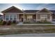 Charming townhouse exterior with brick accents, a cozy front porch, and manicured landscaping at 2929 Rambler Dr, Loganville, GA 30052