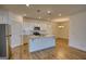 Well-lit kitchen featuring a kitchen island, stainless steel appliances and shaker cabinets at 2929 Rambler Dr, Loganville, GA 30052