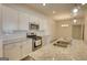 Bright kitchen featuring granite counters and stainless appliances with modern subway tile at 2929 Rambler Dr, Loganville, GA 30052