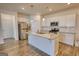 Kitchen boasts white cabinets, granite countertops, stainless steel appliances, and island at 2929 Rambler Dr, Loganville, GA 30052