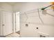 Bright laundry room with tiled floor, shelving and utility connections at 2929 Rambler Dr, Loganville, GA 30052