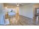 Open living area with modern flooring flows into a bright kitchen with white cabinetry at 2929 Rambler Dr, Loganville, GA 30052