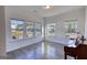 Bright living room with large windows offering neighborhood views and hardwood flooring at 2929 Rambler Dr, Loganville, GA 30052