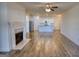 Bright, open-concept space features wood floors, a fireplace, and a view into the kitchen at 2929 Rambler Dr, Loganville, GA 30052