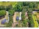 An aerial view of a home surrounded by a lush green forest, a long driveway, and a well-manicured lawn at 1555 South Bethany Rd, Locust Grove, GA 30248