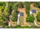 Aerial view of new construction home with spacious yard, driveway, and surrounded by mature trees at 1555 South Bethany Rd, Locust Grove, GA 30248