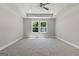 Empty bedroom with a tray ceiling, recessed lights, and large double windows providing ample natural light at 1555 South Bethany Rd, Locust Grove, GA 30248