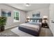 Bedroom with large bed, two bedside tables, two lamps, and a large window with natural lighting and greenery at 1555 South Bethany Rd, Locust Grove, GA 30248