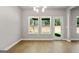 Bright dining area with natural light features wood floors, modern lighting, and access to the outdoors at 1555 South Bethany Rd, Locust Grove, GA 30248