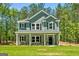 Charming two-story home showcasing a covered porch and manicured lawn at 1555 South Bethany Rd, Locust Grove, GA 30248