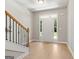 Bright foyer with hardwood floors, staircase, and front door with sidelights at 1555 South Bethany Rd, Locust Grove, GA 30248