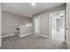 Upstairs hallway with neutral paint, carpeted floors, and multiple doorways leading to various rooms at 1555 South Bethany Rd, Locust Grove, GA 30248