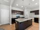 Modern kitchen showcases granite countertops, stainless steel appliances, a kitchen island, and dark cabinetry at 1555 South Bethany Rd, Locust Grove, GA 30248