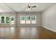 Bright living room with hardwood floors, ceiling fan, and multiple windows at 1555 South Bethany Rd, Locust Grove, GA 30248