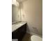 Stylish powder room featuring a granite countertop vanity and modern fixtures at 1555 South Bethany Rd, Locust Grove, GA 30248