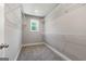 Carpeted walk-in closet with white wire shelving, neutral paint, and a single window for natural light at 1555 South Bethany Rd, Locust Grove, GA 30248