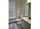 Bathroom with a single vanity, toilet, wood flooring and a window at 2200 Hickory Station Cir, Snellville, GA 30078