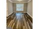 Empty bedroom with wood flooring, large window and white trim at 2200 Hickory Station Cir, Snellville, GA 30078