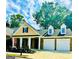 Charming brick home with a two-car garage, manicured lawn, and inviting front porch at 2200 Hickory Station Cir, Snellville, GA 30078