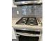 Gourmet kitchen with stainless steel gas range, granite countertops, and stylish backsplash at 2200 Hickory Station Cir, Snellville, GA 30078
