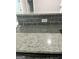 Close-up of granite countertops and grey backsplash with new electrical outlets installed at 2200 Hickory Station Cir, Snellville, GA 30078