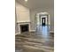 Spacious living room featuring a fireplace, hardwood floors, and arched entryway to the foyer at 2200 Hickory Station Cir, Snellville, GA 30078